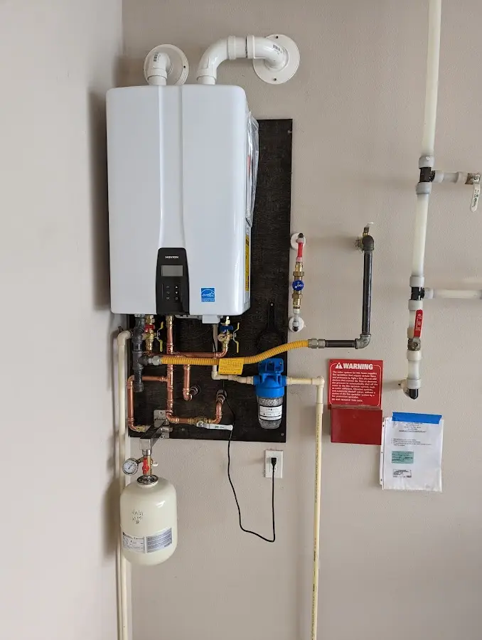 Professional plumber installing copper piping in a North Kensington home